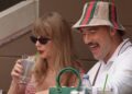 Taylor Swift takes a sip of her drink while seated next to Kansas City Chiefs tight end Travis Kelce on the final day of the U.S. Open tennis tournament, Sept. 8, 2024.