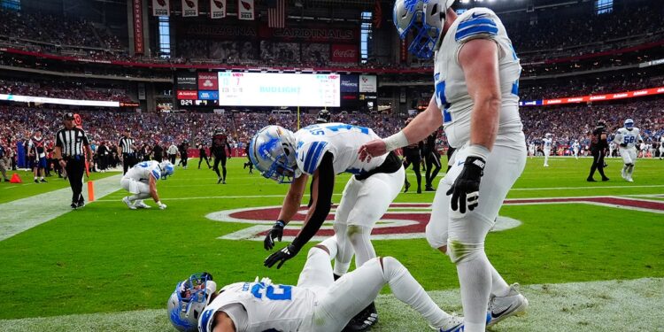 Jahmyr Gibbs lies in end zone