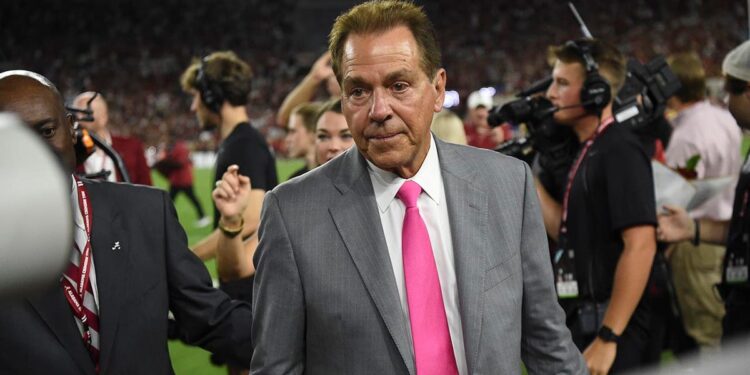 Nick Saban walks off the football field