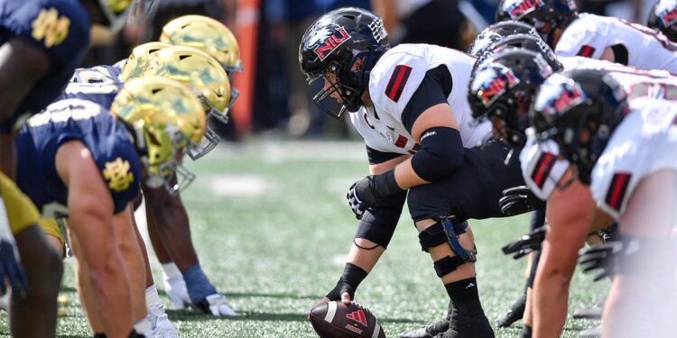 College football players lineup before a snap