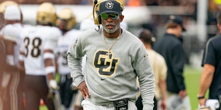 Deion Sanders stands on the sidelines