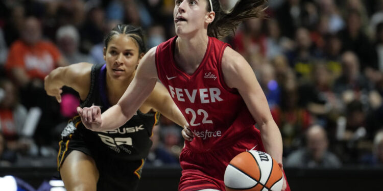 UNCASVILLE, CONNECTICUT - SEPTEMBER 25: Caitlin Clark #22 of the Indiana Fever drives against Veronica Burton #22 of the Connecticut Sun during the third quarter of Game Two of the 2024 WNBA Playoffs first round at Mohegan Sun Arena on September 25, 2024 in Uncasville, Connecticut. (Photo by Joe Buglewicz/Getty Images)