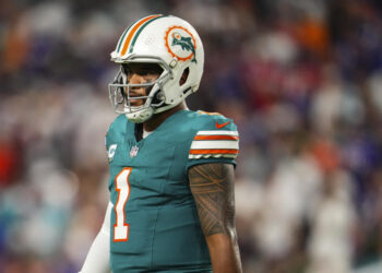 MIAMI GARDENS, FL - SEPTEMBER 12: Tua Tagovailoa #1 of the Miami Dolphins looks on from the field during an NFL football game against the Buffalo Bills at Hard Rock Stadium on September 12, 2024 in Miami Gardens, Florida. (Photo by Cooper Neill/Getty Images)