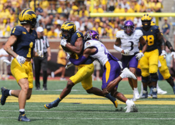 ANN ARBOR, MI - SEPTEMBER 02:  Michigan Wolverines wide receiver Cornelius Johnson (6) runs with the ball after catching a pass while trying to avoid being tackled by East Carolina Pirates defensive back Shavon Revel (28) during the third quarter of a non-conference college football game between the East Carolina Pirates and the Michigan Wolverines on September 2, 2023 at Michigan Stadium in Ann Arbor, Michigan.  (Photo by Scott W. Grau/Icon Sportswire via Getty Images)