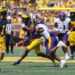 ANN ARBOR, MI - SEPTEMBER 02:  Michigan Wolverines wide receiver Cornelius Johnson (6) runs with the ball after catching a pass while trying to avoid being tackled by East Carolina Pirates defensive back Shavon Revel (28) during the third quarter of a non-conference college football game between the East Carolina Pirates and the Michigan Wolverines on September 2, 2023 at Michigan Stadium in Ann Arbor, Michigan.  (Photo by Scott W. Grau/Icon Sportswire via Getty Images)