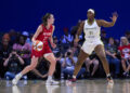 ARLINGTON, TEXAS - JULY 17: Caitlin Clark #22 of the Indiana Fever drives to the basket against Kalani Brown #21 of the Dallas Wings at the College Park Center on July 17, 2024 in Arlington, Texas. NOTE TO USER: User expressly acknowledges and agrees that, by downloading and or using this photograph, User is consenting to the terms and conditions of the Getty Images License Agreement.  (Photo by Cooper Neill/Getty Images)