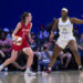 ARLINGTON, TEXAS - JULY 17: Caitlin Clark #22 of the Indiana Fever drives to the basket against Kalani Brown #21 of the Dallas Wings at the College Park Center on July 17, 2024 in Arlington, Texas. NOTE TO USER: User expressly acknowledges and agrees that, by downloading and or using this photograph, User is consenting to the terms and conditions of the Getty Images License Agreement.  (Photo by Cooper Neill/Getty Images)