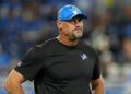 DETROIT, MICHIGAN - SEPTEMBER 08: Head coach Dan Campbell looks on during warmups prior to their game against the Los Angeles Rams at Ford Field on September 08, 2024 in Detroit, Michigan. (Photo by Nic Antaya/Getty Images)