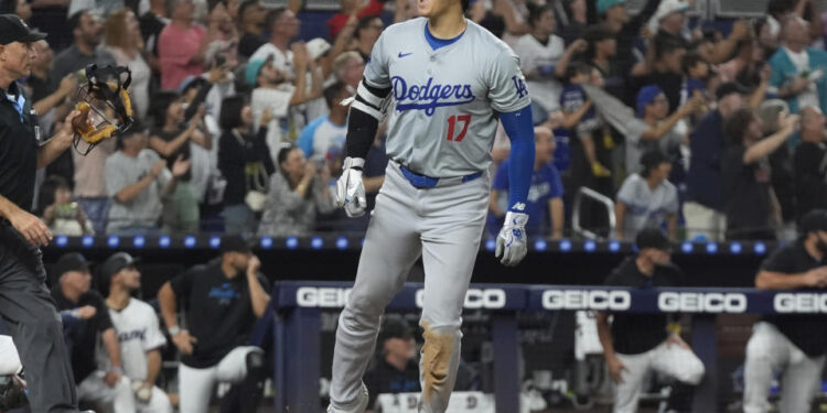 On Thursday in Miami, Shohei Ohtani hit his 49th and 50th home runs of the season, after stealing his 50th and 51st bases, to stand alone in MLB history. (AP Photo/Marta Lavandier)