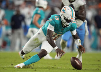 Miami Dolphins quarterback Tyler Huntley (18) goes after the ball after a bad snap against the Titans. (AP Photo/Rebecca Blackwell)