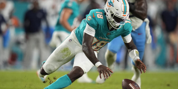 Miami Dolphins quarterback Tyler Huntley (18) goes after the ball after a bad snap against the Titans. (AP Photo/Rebecca Blackwell)