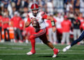 Sep 14, 2024; Logan, Utah, USA;  Utah Utes quarterback Isaac Wilson (11) runs with the ball against the Utah State Aggies at Merlin Olsen Field at Maverik Stadium. Mandatory Credit: Jamie Sabau-Imagn Images