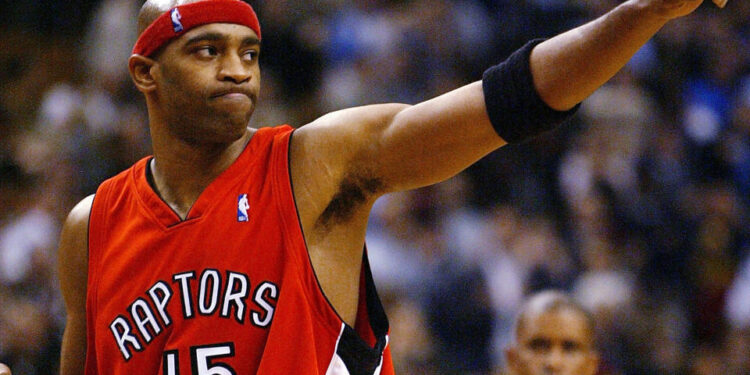 TORONTO - NOVEMBER 3:   Vince Carter #15 of the Toronto Raptors salutes the crowd after beating the Houston Rockets 95-88 during a game at the Air Canada Centre on November 3, 2003 in Toronto, Canada.  NOTE TO USER: User expressly acknowledges and agrees that, by downloading and or using this photograph, User is consenting to the terms and conditions of the Getty Images License Agreement. (Photo by Dave Sandford/Getty Images)