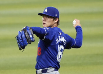 Injured Los Angeles Dodgers starting pitcher Yoshinobu Yamamoto, of Japan, warms up prior to a baseball game against the Arizona Diamondbacks, Sunday, Sept. 1, 2024, in Phoenix. (AP Photo/Ross D. Franklin)