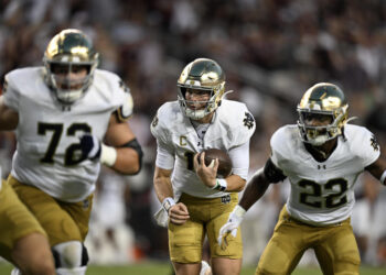 COLLEGE STATION, TEXAS - AUGUST 31: Riley Leonard #13 of the Notre Dame Fighting Irish runs the ball as Sam Pendleton #72 and Devyn Ford #22 block against the Texas A&M Aggies at Kyle Field on August 31, 2024 in College Station, Texas. (Photo by Jack Gorman/Getty Images)