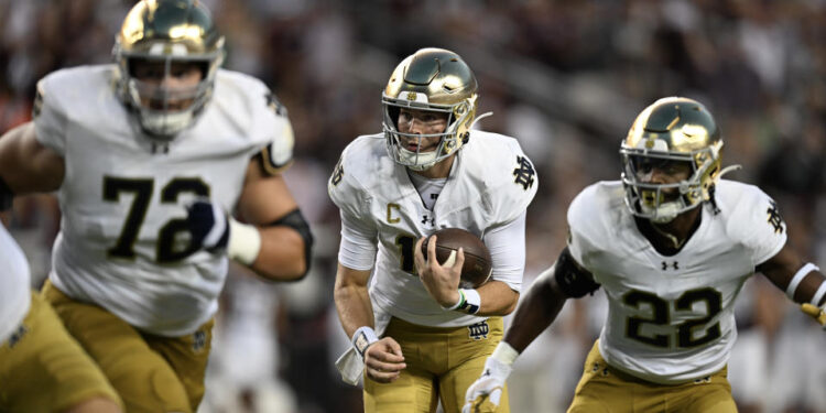 COLLEGE STATION, TEXAS - AUGUST 31: Riley Leonard #13 of the Notre Dame Fighting Irish runs the ball as Sam Pendleton #72 and Devyn Ford #22 block against the Texas A&M Aggies at Kyle Field on August 31, 2024 in College Station, Texas. (Photo by Jack Gorman/Getty Images)