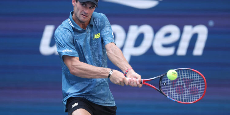 NEW YORK, NEW YORK - AUGUST 31: Tommy Paul of the United States returns a shot against Gabriel Diallo of Canada during their Men's Singles Third Round match on Day Six of the 2024 US Open at USTA Billie Jean King National Tennis Center on August 31, 2024 in the Flushing neighborhood of the Queens borough of New York City. (Photo by Matthew Stockman/Getty Images)