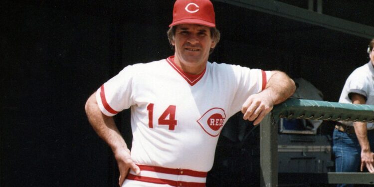 Pete Rose poses on dugout