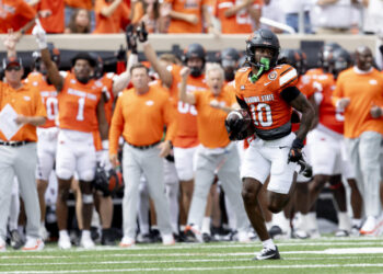 Oklahoma State cornerback Kale Smith (10) returns a interception for a touchdown in the first half of an NCAA college football game against Arkansas, Saturday, Sept. 7, 2024, in Stillwater, Okla. (AP Photo/Mitch Alcala)