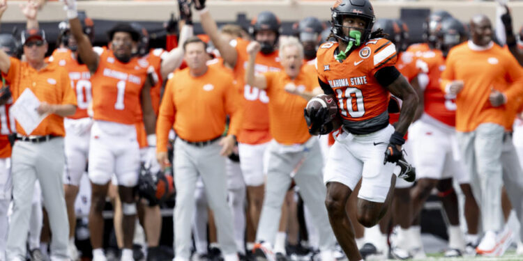 Oklahoma State cornerback Kale Smith (10) returns a interception for a touchdown in the first half of an NCAA college football game against Arkansas, Saturday, Sept. 7, 2024, in Stillwater, Okla. (AP Photo/Mitch Alcala)