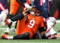 CINCINNATI, OHIO - SEPTEMBER 08: Joe Burrow #9 of the Cincinnati Bengals is hit in the helmet by the cleat of Jabrill Peppers #5 of the New England Patriots in the second quarter of the game at Paycor Stadium on September 08, 2024 in Cincinnati, Ohio. (Photo by Dylan Buell/Getty Images)