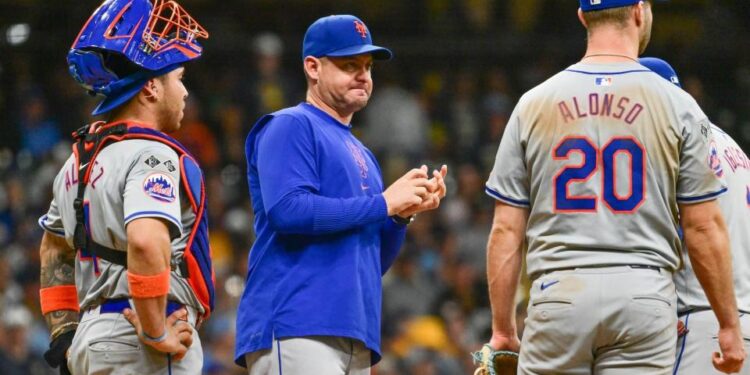 Sep 28, 2024; Milwaukee, Wisconsin, USA; New York Mets manager Carlos Mendoza makes a pitching change in the eighth inning against the Milwaukee Brewers at American Family Field.