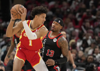 Jalen Johnson #1 of the Atlanta Hawks handles the ball against Torrey Craig #13 of the Chicago Bulls during the second half at the United Center on April 01, 2024 in Chicago, Illinois. NOTE TO USER: User expressly acknowledges and agrees that, by downloading and or using this photograph, User is consenting to the terms and conditions of the Getty Images License Agreement. (Photo by Patrick McDermott/Getty Images)