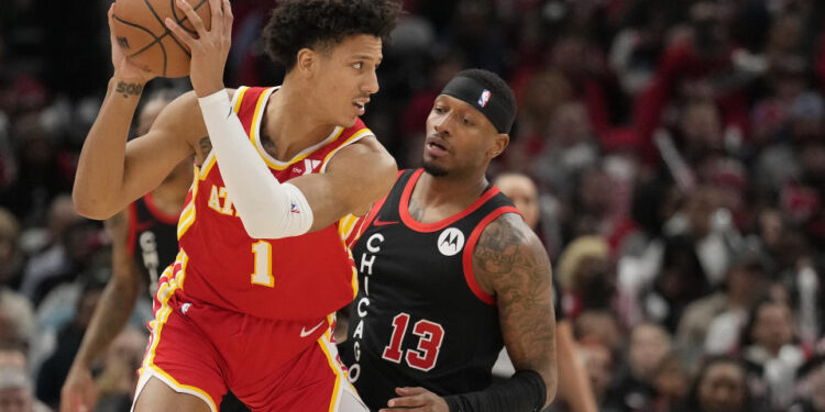 Jalen Johnson #1 of the Atlanta Hawks handles the ball against Torrey Craig #13 of the Chicago Bulls during the second half at the United Center on April 01, 2024 in Chicago, Illinois. NOTE TO USER: User expressly acknowledges and agrees that, by downloading and or using this photograph, User is consenting to the terms and conditions of the Getty Images License Agreement. (Photo by Patrick McDermott/Getty Images)