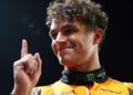 Lando Norris lifts his index finger in celebration after taking pole position for the Singapore Grand Prix