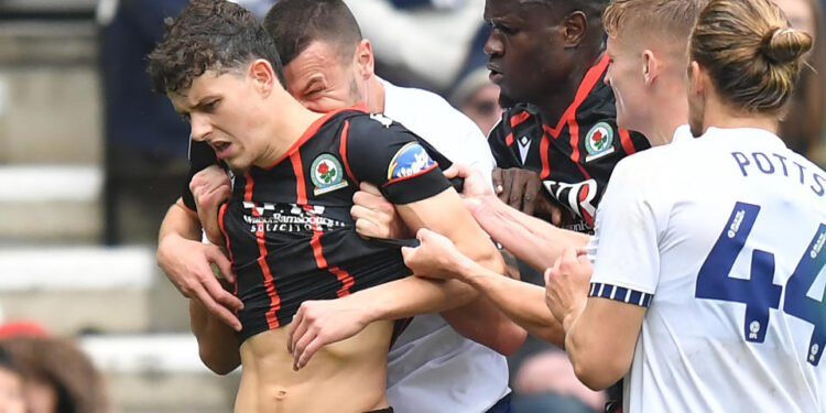 Blackburn Rovers' Owen Beck seems to be bitten on the neck by Preston North End's Milutin Osmajic during a match. (Dave Howarth - CameraSport via Getty Images)