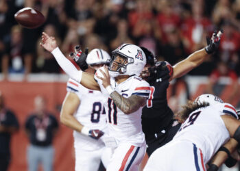 SALT LAKE CITY, UT - SEPTEMBER 28: Noah Fifita #11 of the Arizona Wildcats throws under pressure from the Utah Utes during the first half of their game at Rice Eccles Stadium on September 28, 2024 in Salt Lake City, Utah. (Photo by Chris Gardner/Getty Images)