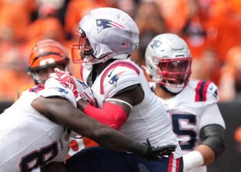 Jabrill Peppers of New England Patriots is hit by Joe Burrow of Cincinnati Bengals