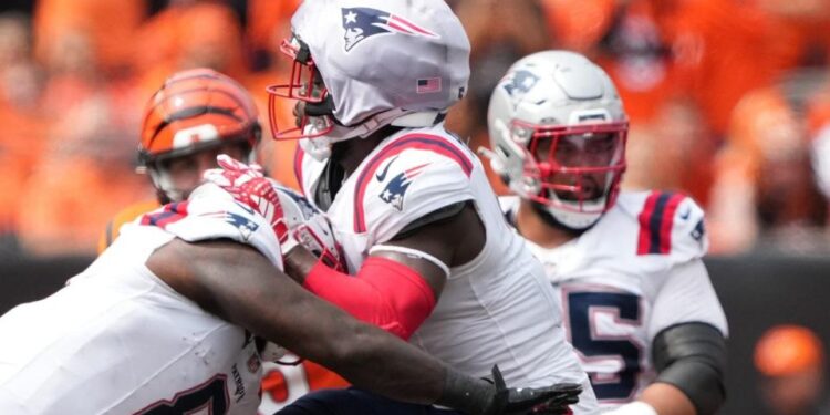 Jabrill Peppers of New England Patriots is hit by Joe Burrow of Cincinnati Bengals