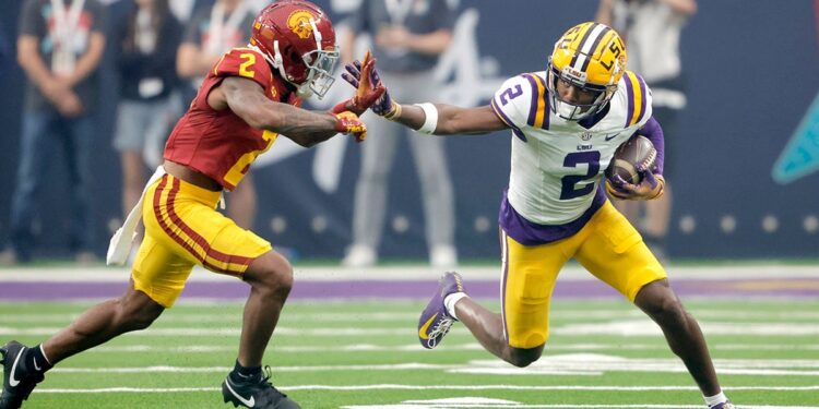 Kyren Lacy fends off a tackle