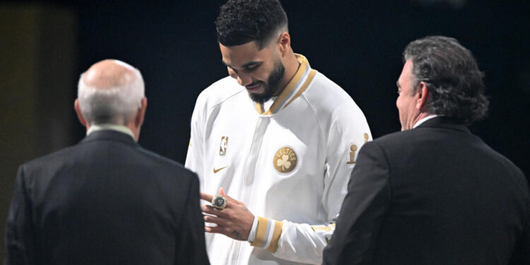 BOSTON, MASSACHUSETTS - OCTOBER 22: Jayson Tatum #0 of the Boston Celtics receives his championship ring from Boston Celtics owners Robert Epstein and Wyc Grousbeck prior to the game against the New York Knicks at TD Garden on October 22, 2024 in Boston, Massachusetts. (Photo by Brian Fluharty/Getty Images)