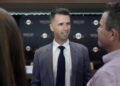 San Francisco Giants president of baseball operations Buster Posey speaks with people after a news conference in San Francisco, Tuesday, Oct. 1, 2024. (AP Photo/Jeff Chiu)