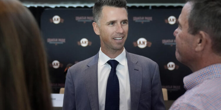 San Francisco Giants president of baseball operations Buster Posey speaks with people after a news conference in San Francisco, Tuesday, Oct. 1, 2024. (AP Photo/Jeff Chiu)