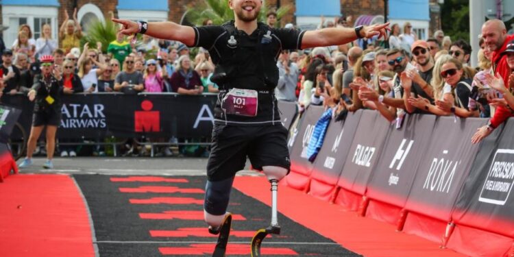 Billy Monger celebrates after completing IRONMAN 70.3 Weymouth on September 15, 2024 in Weymouth, England.