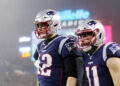 FOXBOROUGH, MASSACHUSETTS - JANUARY 04: Tom Brady #12 of the New England Patriots and Julian Edelman #11 look on after Edelman scored a touchdown in the second quarter of the AFC Wild Card Playoff game at Gillette Stadium on January 04, 2020 in Foxborough, Massachusetts. (Photo by Maddie Meyer/Getty Images)