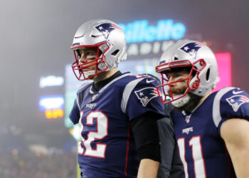 FOXBOROUGH, MASSACHUSETTS - JANUARY 04: Tom Brady #12 of the New England Patriots and Julian Edelman #11 look on after Edelman scored a touchdown in the second quarter of the AFC Wild Card Playoff game at Gillette Stadium on January 04, 2020 in Foxborough, Massachusetts. (Photo by Maddie Meyer/Getty Images)