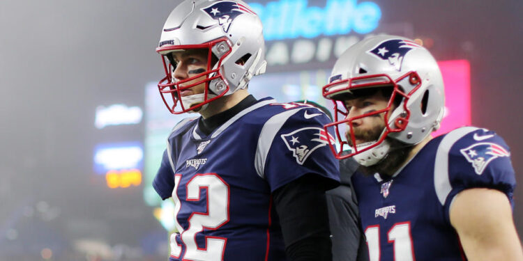 FOXBOROUGH, MASSACHUSETTS - JANUARY 04: Tom Brady #12 of the New England Patriots and Julian Edelman #11 look on after Edelman scored a touchdown in the second quarter of the AFC Wild Card Playoff game at Gillette Stadium on January 04, 2020 in Foxborough, Massachusetts. (Photo by Maddie Meyer/Getty Images)