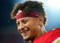 Patrick Mahomes smiles on field