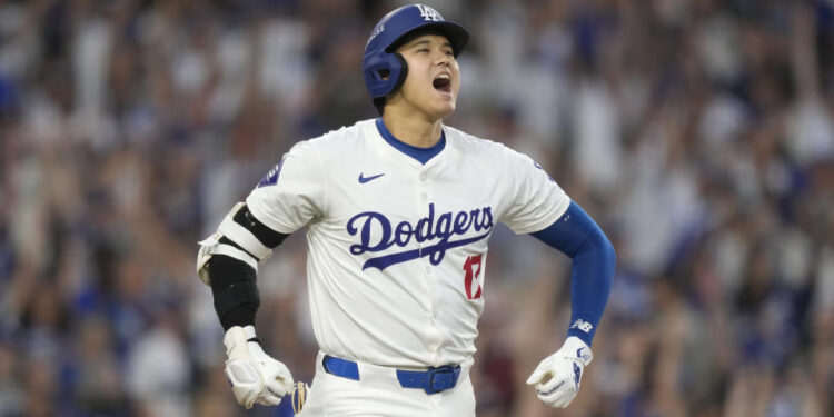 Los Angeles Dodgers' Shohei Ohtani reacts after hitting a three-run home run during the second inning in Game 1 of baseball's NL Division Series against the San Diego Padres, Saturday, Oct. 5, 2024, in Los Angeles. (AP Photo/Mark J. Terrill)