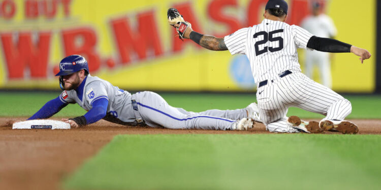 NEW YORK, NEW YORK - OCTOBER 07: Gleyber Torres #25 of the New York Yankees tags out Kyle Isbel #28 of the Kansas City Royals attempting to steal second base in the seventh inning during Game Two of the Division Series at Yankee Stadium on October 07, 2024 in New York City. (Photo by Elsa/Getty Images)