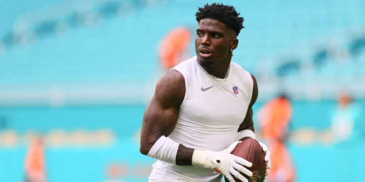 Aug 17, 2024; Miami Gardens, Florida, USA; Miami Dolphins wide receiver Tyreek Hill (10) throws the football before preseason game against the Washington Commanders at Hard Rock Stadium. Mandatory Credit: Sam Navarro-Imagn Images