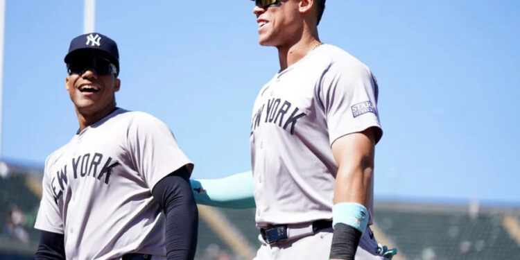 New York Yankees center fielder Aaron Judge (99) and right fielder Juan Soto (22) walk towards the dugout before the start of the fourth inning against the Oakland Athletics at the Oakland-Alameda County Coliseum. Mandatory Credit: Cary Edmondson-Imagn Images