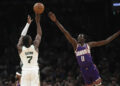 Mar 14, 2024; Boston, Massachusetts, USA; Boston Celtics guard Jaylen Brown (7) shoots the ball over Phoenix Suns center Bol Bol (11) during the first half at TD Garden. credits: Bob DeChiara-USA TODAY Sports