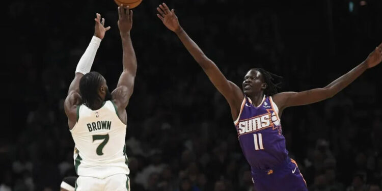 Mar 14, 2024; Boston, Massachusetts, USA; Boston Celtics guard Jaylen Brown (7) shoots the ball over Phoenix Suns center Bol Bol (11) during the first half at TD Garden. credits: Bob DeChiara-USA TODAY Sports