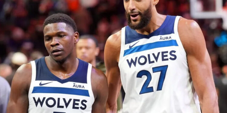 Apr 26, 2024; Phoenix, Arizona, USA; Minnesota Timberwolves guard Anthony Edwards (5) and Minnesota Timberwolves center Rudy Gobert (27) talk during the first half of game three of the first round for the 2024 NBA playoffs against the Phoenix Suns at Footprint Center. credits: Joe Camporeale-USA TODAY Sports