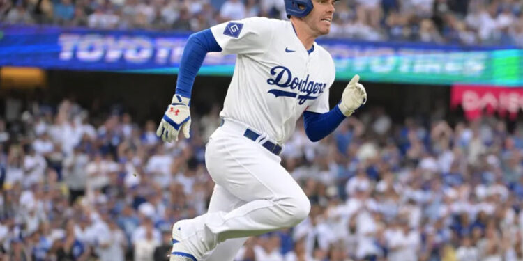 Oct 11, 2024; Los Angeles, California, USA; Los Angeles Dodgers first baseman Freddie Freeman (5) runs after hitting a single in the first inning during game five of the NLDS for the 2024 MLB Playoffs at Dodger Stadium. Mandatory Credit: Jayne Kamin-Oncea-Imagn Images